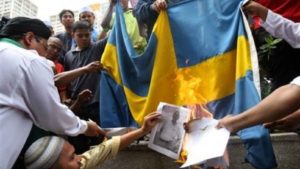 This photo of a flag burning was taken in Pakistan. But it was used by Right Wing websites as proof of Sweden's collapse.